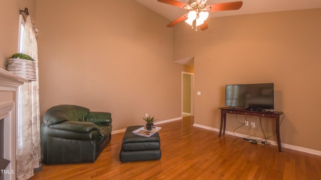133 Parkhaven Ln, Garner, NC 27529 - living area with ceiling fan, wood finished floors, baseboards, high vaulted ceiling, and a fireplace