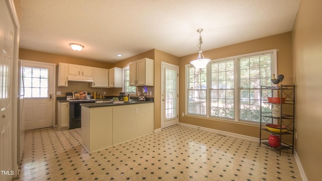 133 Parkhaven Ln, Garner, NC 27529 - kitchen with range, under cabinet range hood, dark countertops, and baseboards