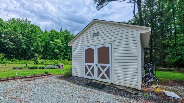 view of shed with a forest view