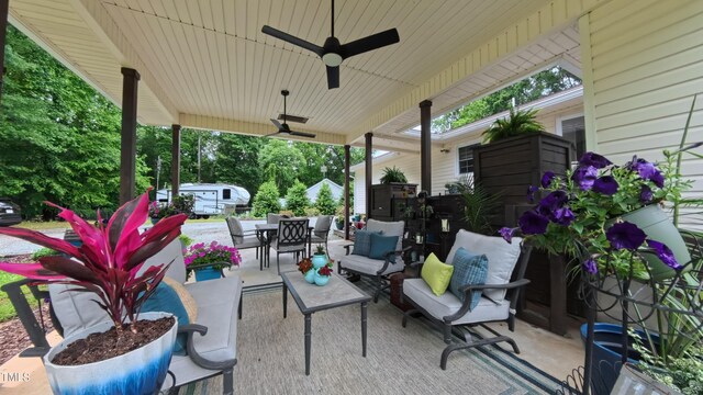 view of patio / terrace featuring outdoor dining space, a ceiling fan, and an outdoor living space