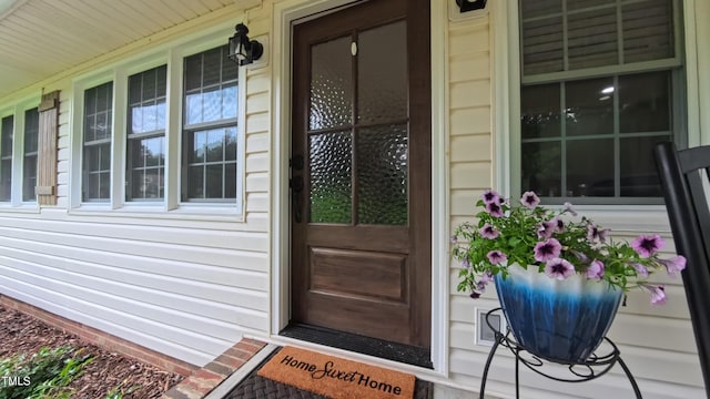 view of exterior entry with covered porch