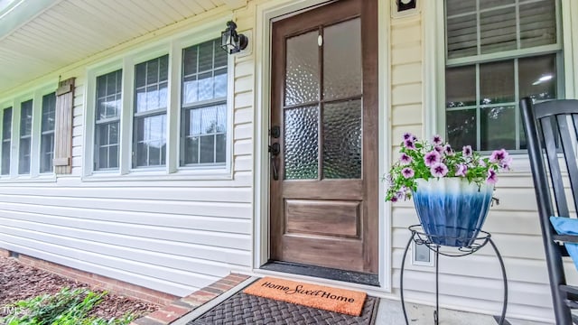 view of exterior entry featuring a porch