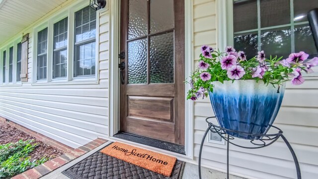 view of exterior entry with covered porch