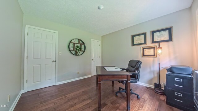 office area featuring dark wood-style flooring, baseboards, and a textured ceiling