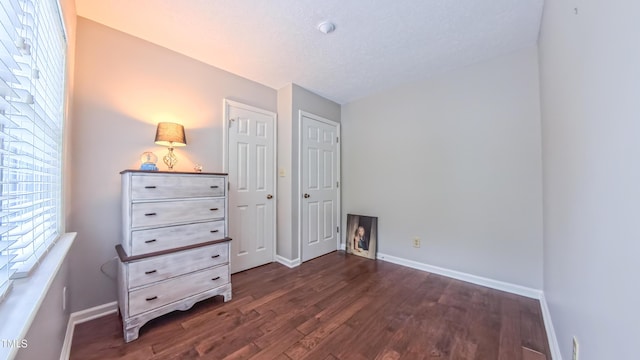 bedroom featuring wood finished floors and baseboards