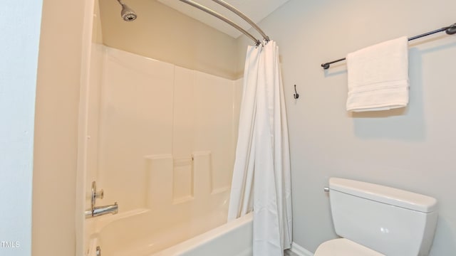 full bathroom with toilet and shower / bath combo with shower curtain