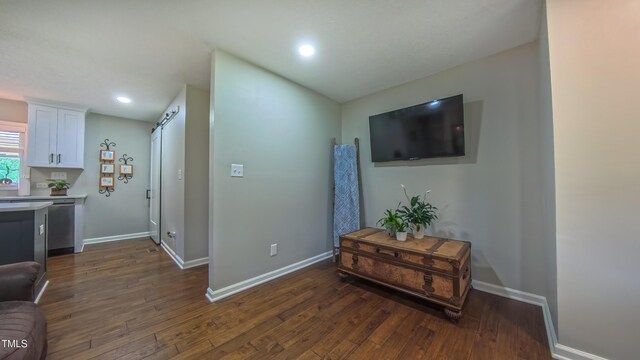 living room with dark wood-style flooring, baseboards, and recessed lighting
