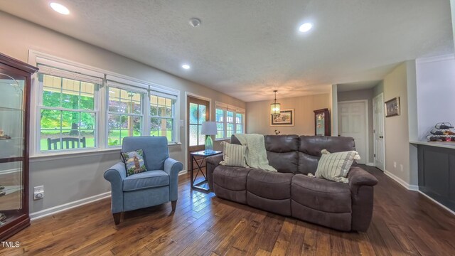 living room with dark wood finished floors, baseboards, and recessed lighting
