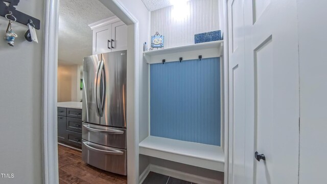 mudroom with a textured ceiling and dark wood-style floors