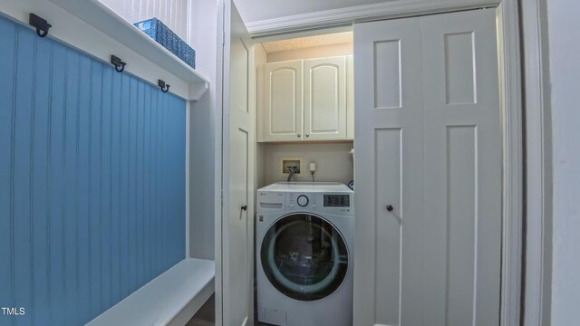 laundry room featuring washer / dryer and cabinet space