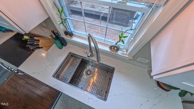 detailed view of a sink and light stone countertops