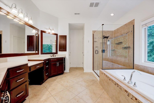 bathroom featuring a stall shower, a bath, tile patterned flooring, vanity, and baseboards