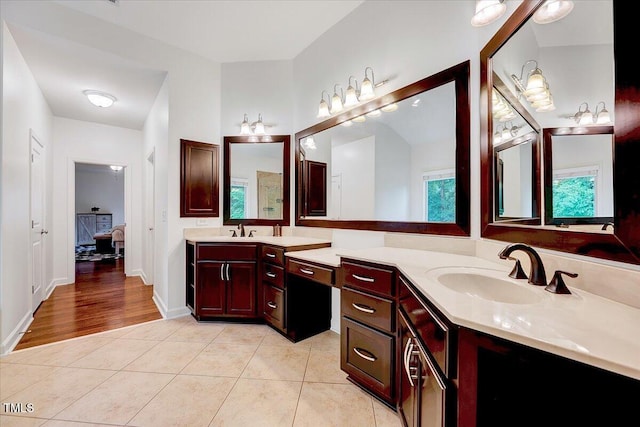 full bathroom with tile patterned floors, vanity, and baseboards