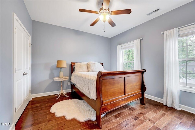 bedroom featuring wood finished floors, baseboards, and ceiling fan