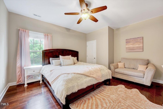 bedroom with dark wood finished floors, baseboards, and ceiling fan