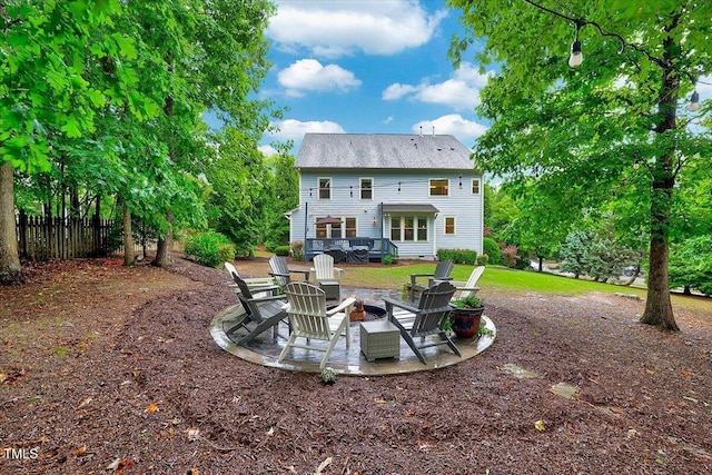 back of house featuring a fire pit, a patio area, and fence