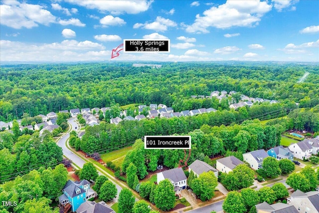 aerial perspective of suburban area with a forest