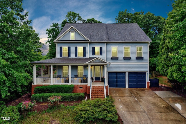 view of front facade with covered porch, concrete driveway, an attached garage, and a shingled roof