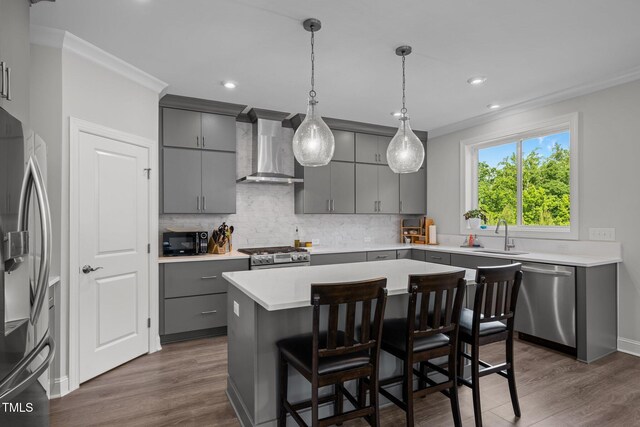 192 Logbridge Rd, Chapel Hill, NC 27516 - kitchen featuring gray cabinets, appliances with stainless steel finishes, wall chimney range hood, ornamental molding, and a sink