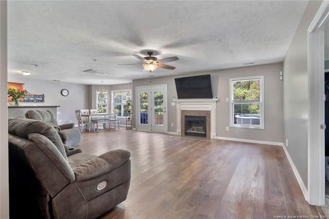 1624 Citation Ct, Parkton, NC 28371 - living room featuring ceiling fan, wood finished floors, a textured ceiling, and a fireplace