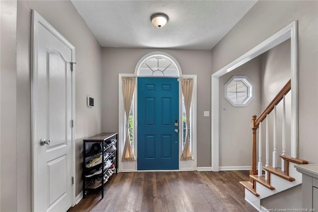 1624 Citation Ct, Parkton, NC 28371 - foyer entrance featuring wood finished floors, stairs, and a textured ceiling