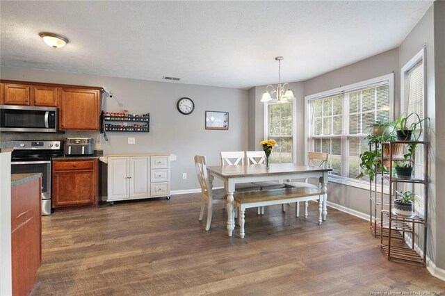 1624 Citation Ct, Parkton, NC 28371 - dining space with a chandelier and dark wood-style floors