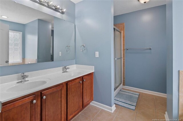 1624 Citation Ct, Parkton, NC 28371 - bathroom featuring a stall shower, double vanity, and tile patterned flooring