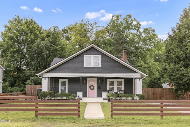 bungalow-style home with covered porch and a chimney