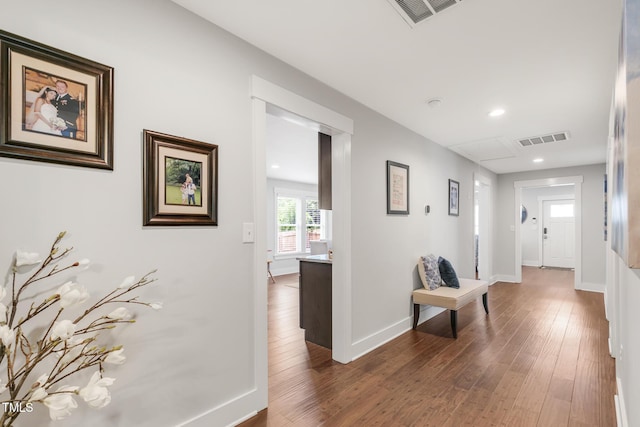 hallway featuring hardwood / wood-style floors, recessed lighting, and baseboards