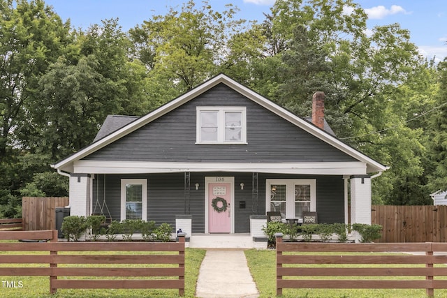 bungalow with a porch and a chimney