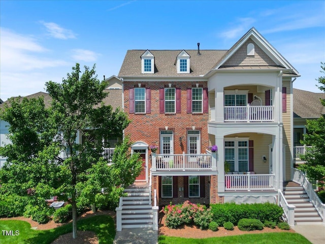 10520 Sablewood Dr Unit 103, Raleigh, NC 27617 - view of front of home featuring stairs, brick siding, a porch, and a balcony