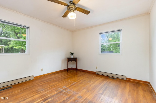 unfurnished room featuring a baseboard radiator, light wood-style flooring, baseboards, a baseboard heating unit, and crown molding