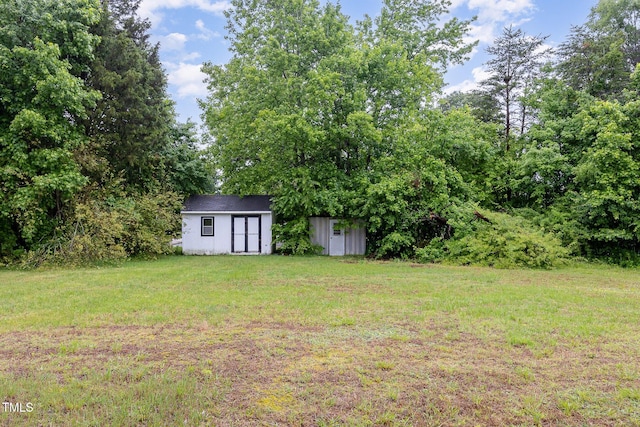 view of grassy yard featuring an outbuilding