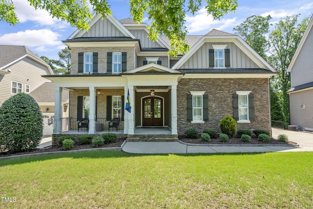 117 Synandra Ln, Holly Springs, NC 27540 - craftsman inspired home featuring board and batten siding, a porch, a front lawn, and brick siding