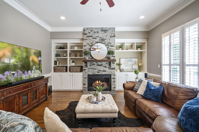 117 Synandra Ln, Holly Springs, NC 27540 - living area with a ceiling fan, ornamental molding, built in features, a fireplace, and wood finished floors