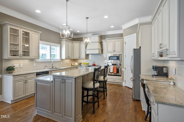 117 Synandra Ln, Holly Springs, NC 27540 - kitchen featuring stainless steel appliances, a center island, decorative backsplash, a sink, and a breakfast bar area