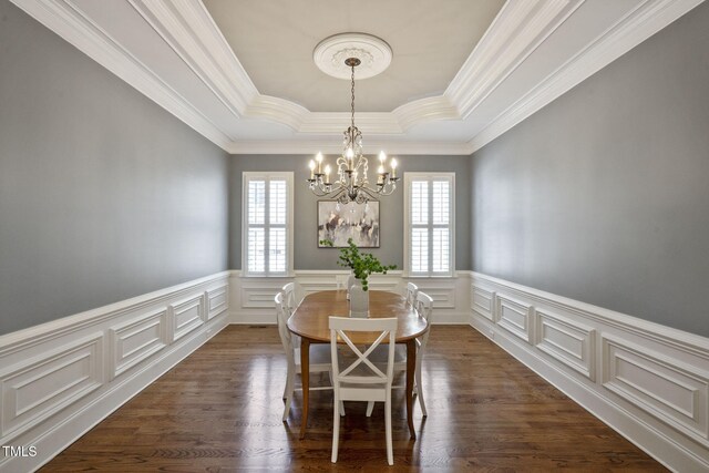 117 Synandra Ln, Holly Springs, NC 27540 - dining space featuring a tray ceiling, a chandelier, ornamental molding, a decorative wall, and a wainscoted wall