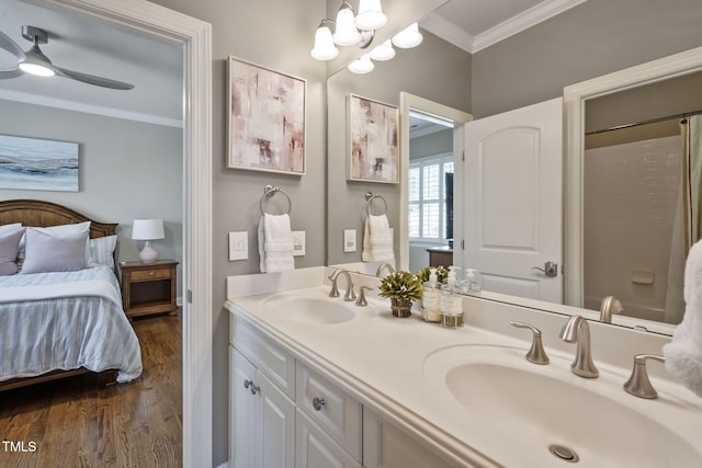 117 Synandra Ln, Holly Springs, NC 27540 - ensuite bathroom featuring ornamental molding, wood finished floors, double vanity, ceiling fan, and a chandelier