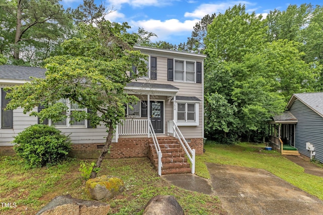 view of front facade with a porch, crawl space, roof with shingles, and a front lawn