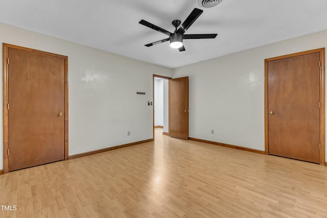 unfurnished bedroom featuring light wood-type flooring, baseboards, and ceiling fan