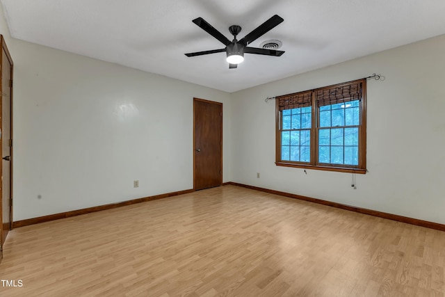 spare room with light wood-style floors, baseboards, and a ceiling fan
