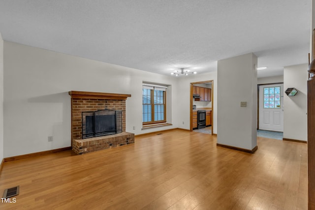 unfurnished living room featuring light wood-style flooring and baseboards
