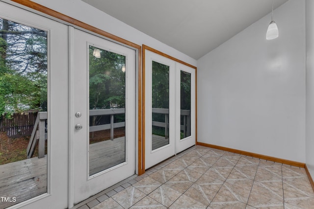 entryway with lofted ceiling and baseboards