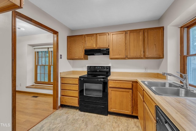 kitchen featuring black appliances, a sink, under cabinet range hood, and butcher block countertops