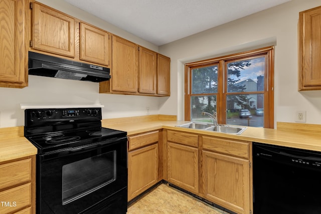 kitchen featuring black appliances, under cabinet range hood, a sink, and butcher block countertops