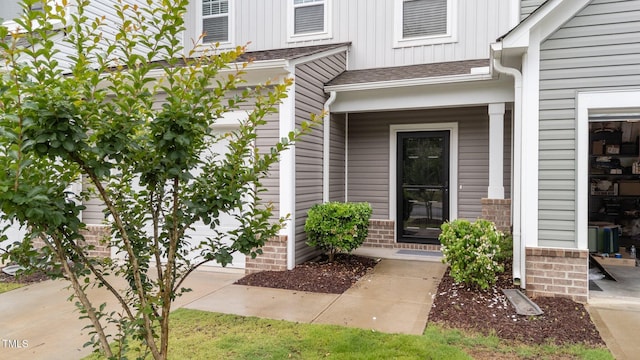 19 Willow Green Dr, Clayton, NC 27527 - view of exterior entry with board and batten siding, a shingled roof, and a porch