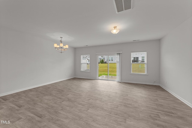 19 Willow Green Dr, Clayton, NC 27527 - unfurnished room with a chandelier, baseboards, and wood finished floors
