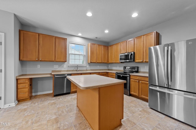 3705 Rivermist Dr, Raleigh, NC 27610 - kitchen with stainless steel appliances, light countertops, a sink, a kitchen island, and recessed lighting