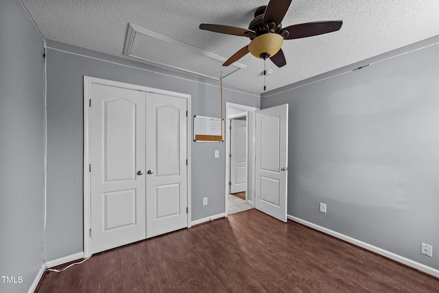 3705 Rivermist Dr, Raleigh, NC 27610 - unfurnished bedroom featuring attic access, a textured ceiling, wood finished floors, a closet, and baseboards