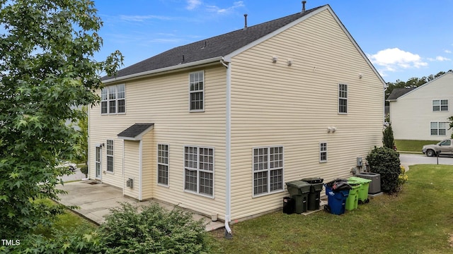 3705 Rivermist Dr, Raleigh, NC 27610 - back of property with cooling unit, a lawn, and a patio